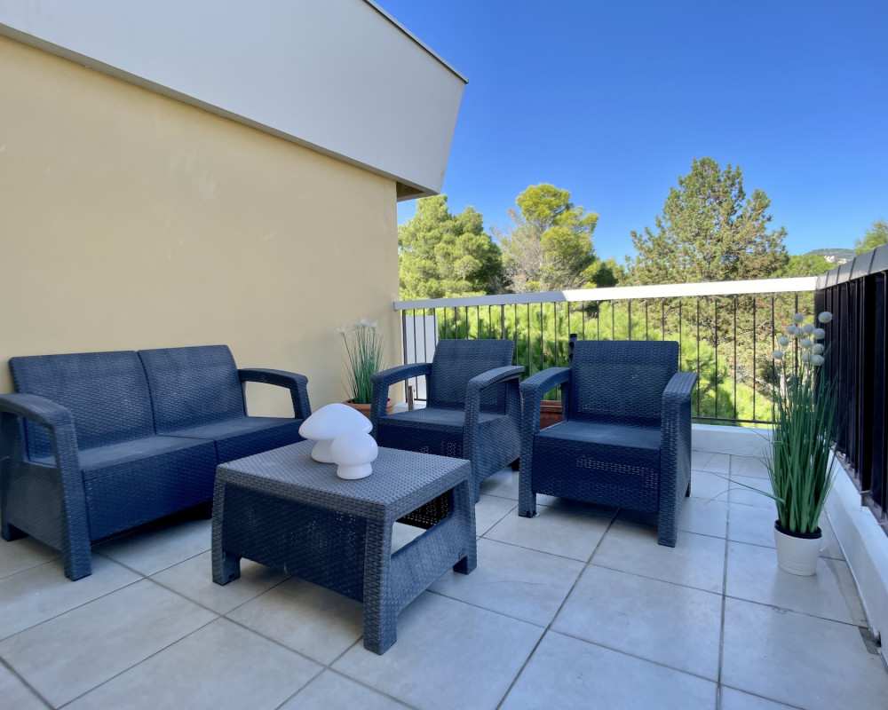 Top-floor apartment with a large terrace and views of the sea and hills.