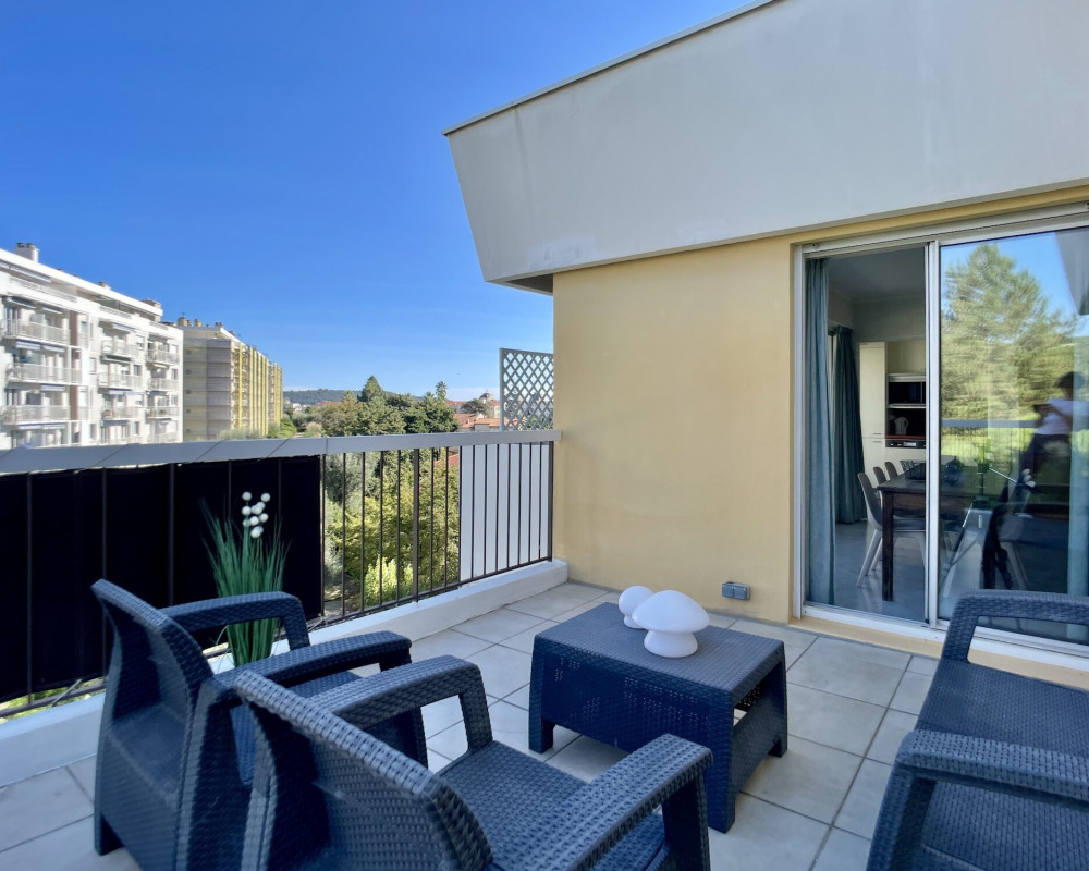 Top-floor apartment with a large terrace and views of the sea and hills.